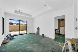 Unfurnished room with a tray ceiling