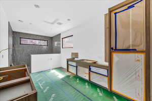 Unfurnished bedroom featuring attic access