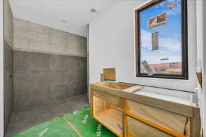 Bathroom featuring vanity and tiled shower