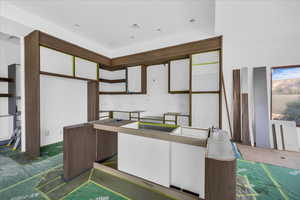 Kitchen featuring a center island and white cabinets