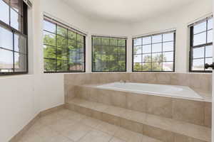 Bathroom featuring light tile patterned floors and a bath