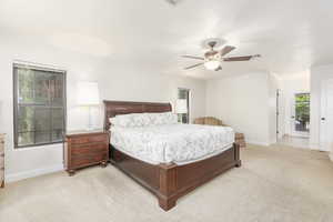 Bedroom with light colored carpet, a ceiling fan, and crown molding