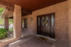 View of exterior entry with covered porch