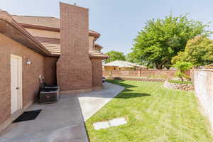 Fenced backyard with a patio area