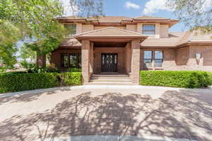 Property entrance with a tiled roof and stucco siding
