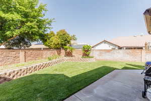 Fenced backyard featuring a patio