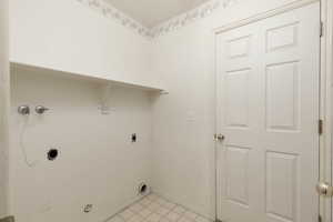 Laundry area featuring light flooring, hookup for an electric dryer, and washer hookup