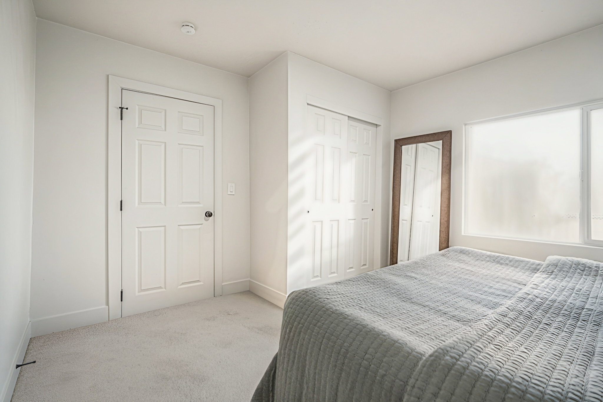 Bedroom featuring carpet and a closet