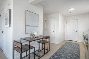 Foyer with light wood-style flooring and baseboards