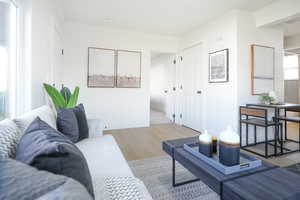 Living room featuring wood finished floors and ornamental molding