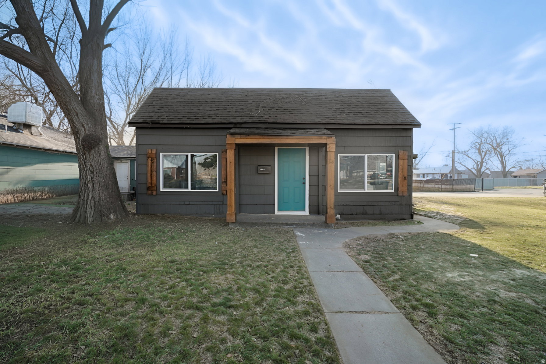 Bungalow-style house featuring roof with shingles