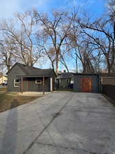 View of front facade with an outbuilding and concrete driveway
