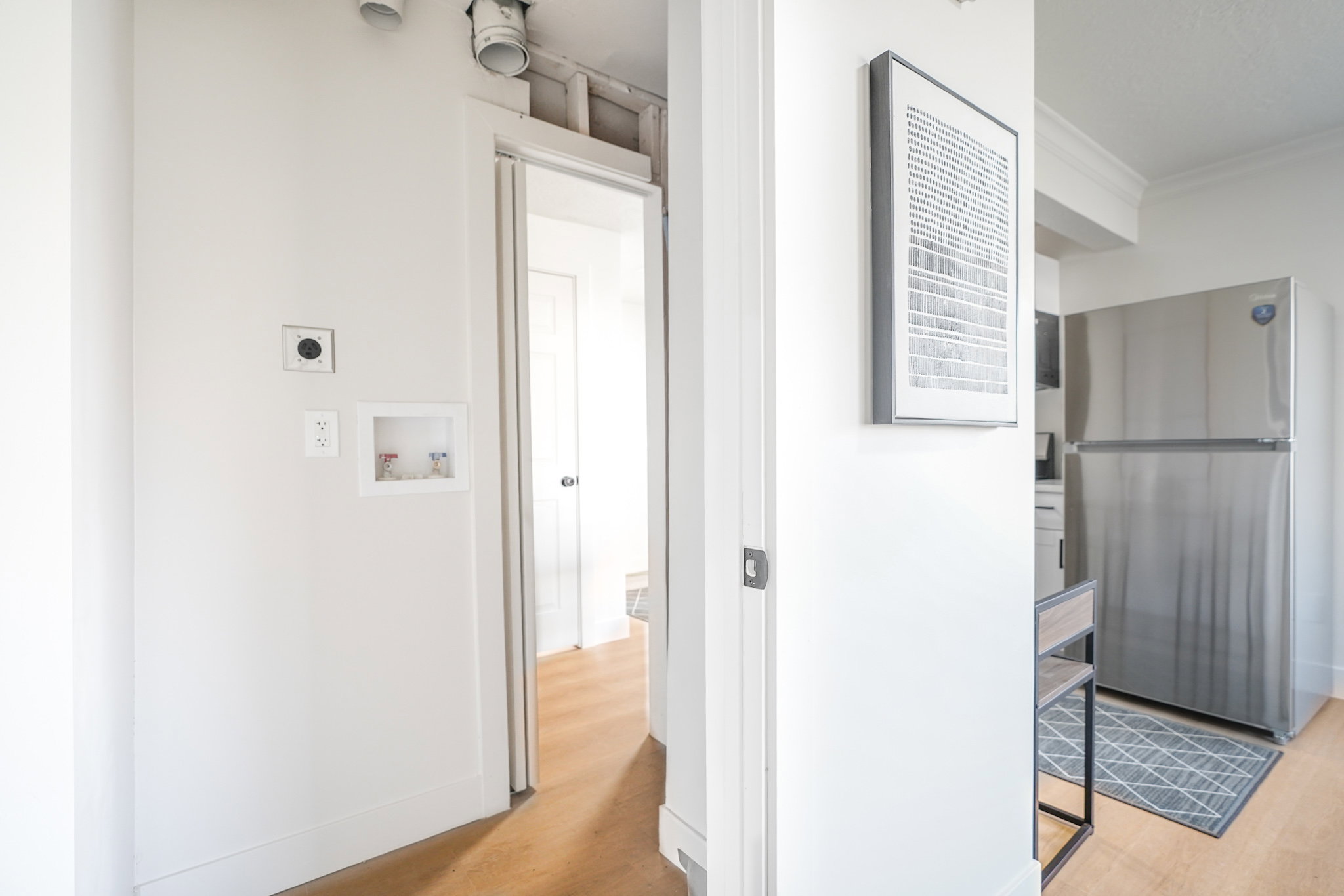 Hall featuring ornamental molding and light wood-type flooring