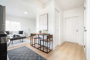 Hallway featuring light wood-type flooring and recessed lighting