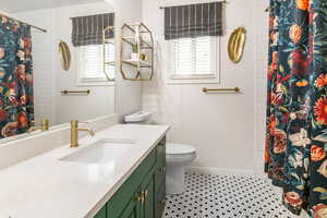 Full bath featuring a shower with curtain and vanity