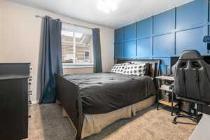 Bedroom featuring light carpet and a ceiling fan