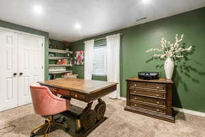 Office space featuring light colored carpet and baseboards