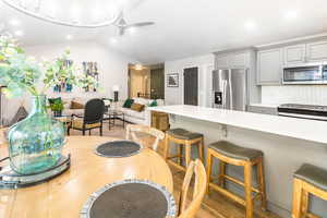 Dining space with light wood finished floors and ceiling fan
