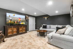 Living area with carpet floors and recessed lighting