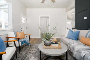 Living area featuring a ceiling fan and wood finished floors