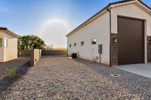 View of home's exterior featuring a fenced backyard, stucco siding, and driveway