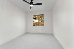 Unfurnished room featuring light colored carpet and a ceiling fan