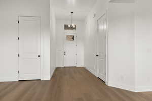 Entrance foyer featuring a chandelier and dark wood-style floors