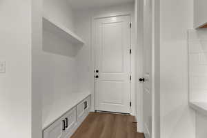 Mudroom featuring dark wood-style flooring