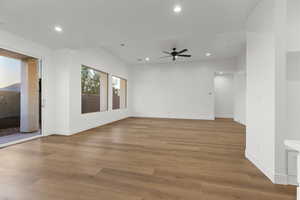 Empty room with ceiling fan, recessed lighting, and light wood-style floors