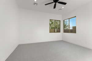 Empty room featuring carpet, ceiling fan, and recessed lighting