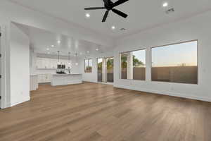 Unfurnished living room featuring ceiling fan, light wood-type flooring, and recessed lighting