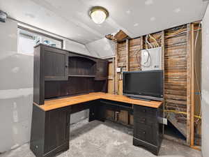 Unfurnished office featuring concrete flooring and electric panel