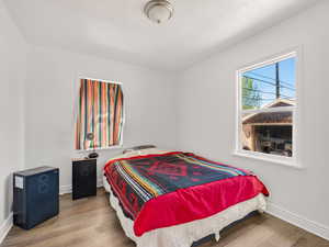 Bedroom with light wood-style flooring and baseboards