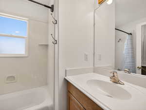 Full bathroom with vanity and shower / bath combination with curtain