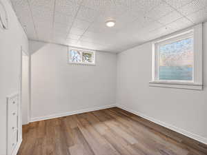 Basement with wood finished floors and baseboards