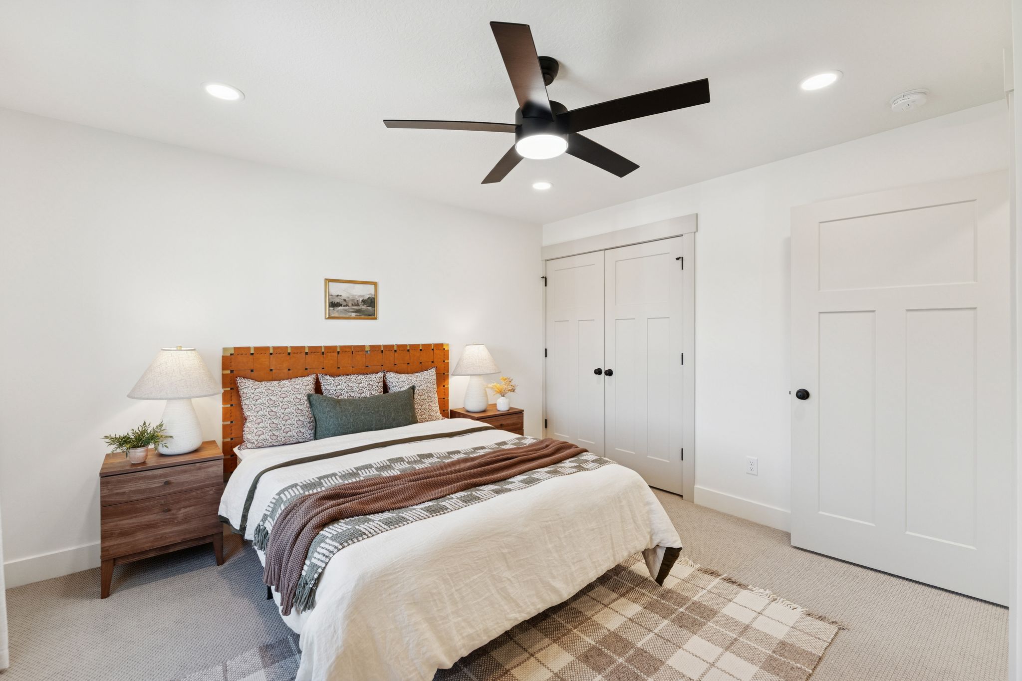 Bedroom with light carpet, a ceiling fan, a closet, and recessed lighting