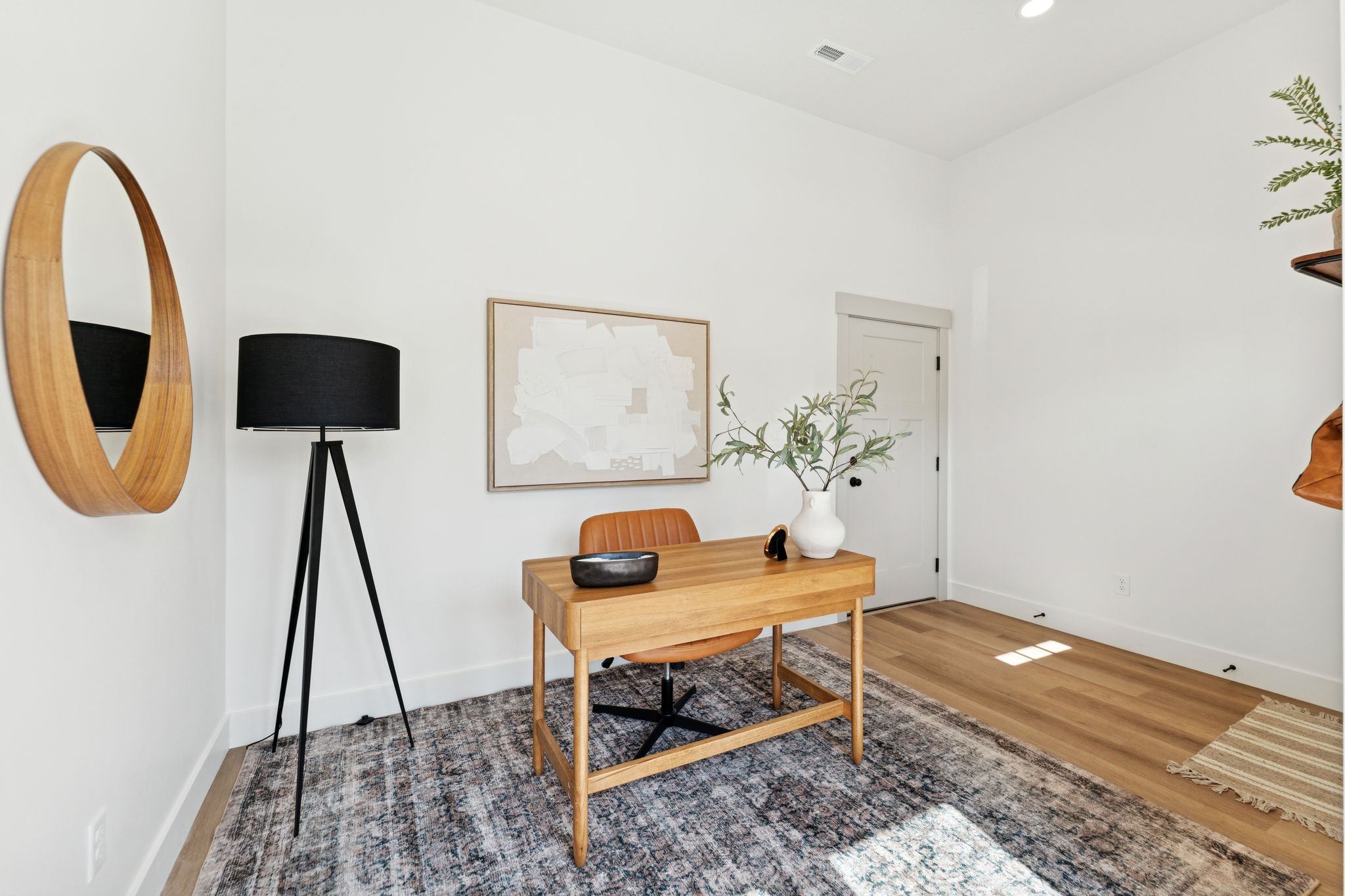 Office with wood finished floors and recessed lighting