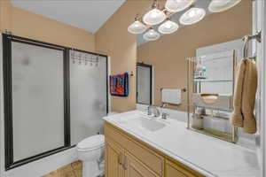 Bathroom featuring a stall shower, vanity, and light tile patterned floors