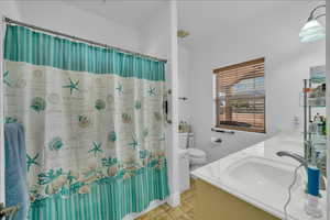 Full bathroom featuring toilet and double vanity