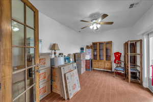 Office area featuring a ceiling fan and wood finish floors