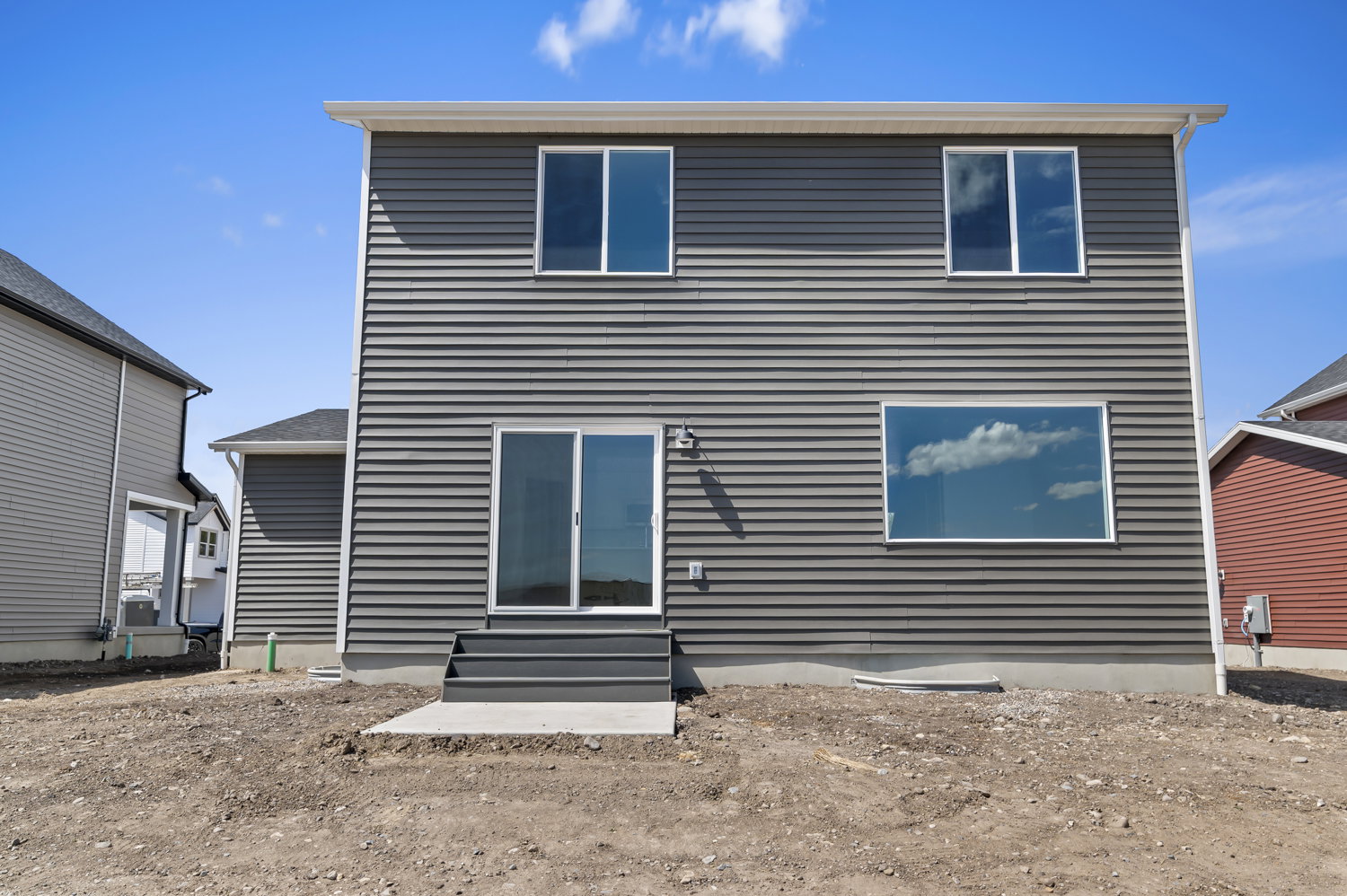 Contemporary exterior with dark gray horizontal siding and white trim