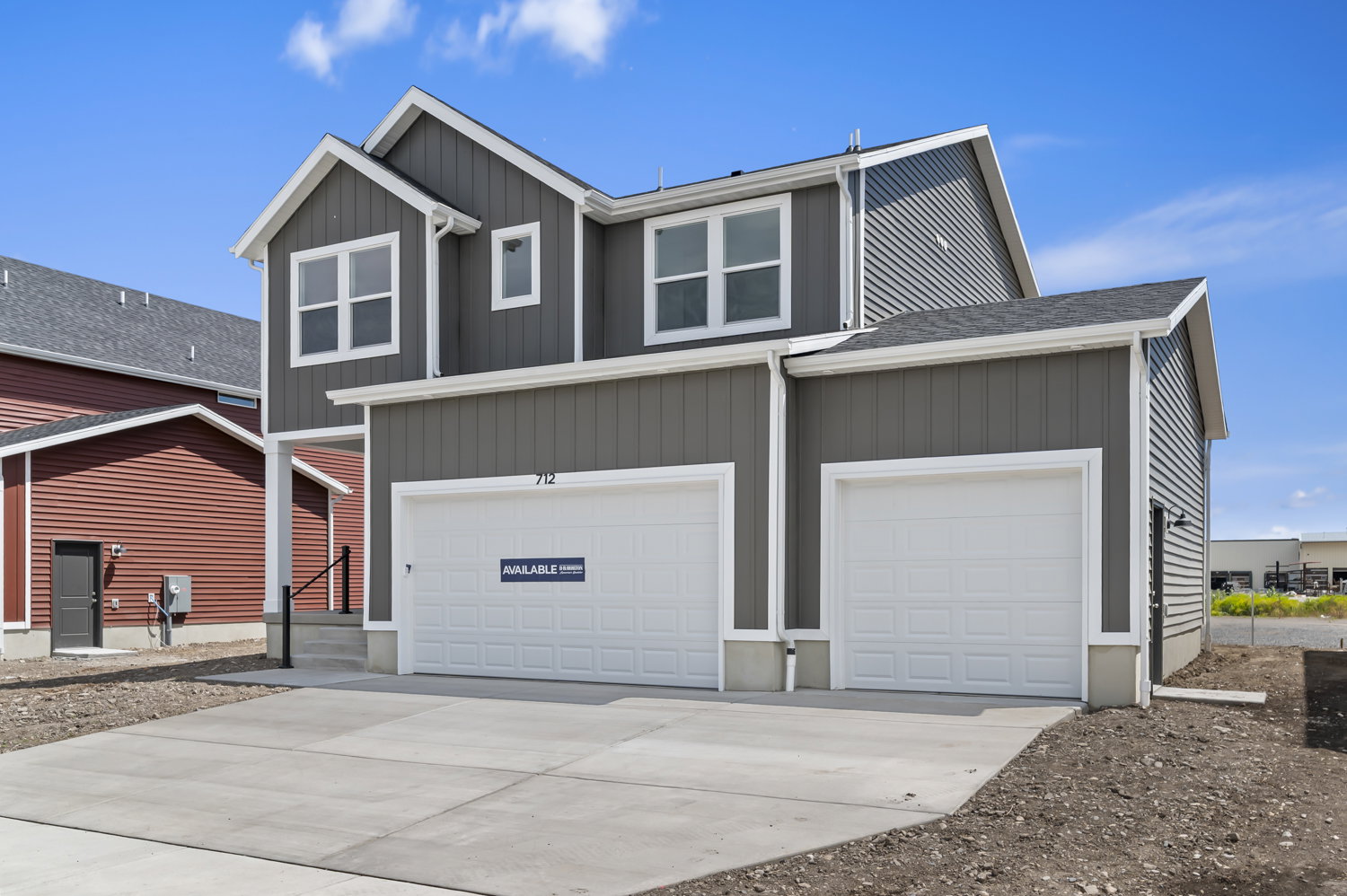 Two-story residential structure featuring dark gray vertical and horizontal siding
