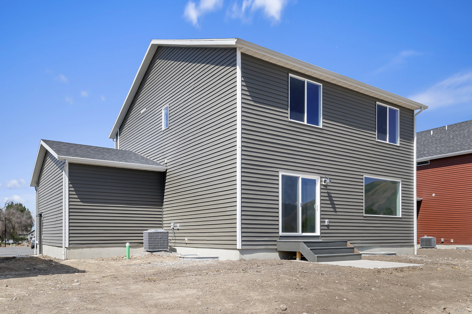 Two-story home featuring gray horizontal siding and white trim