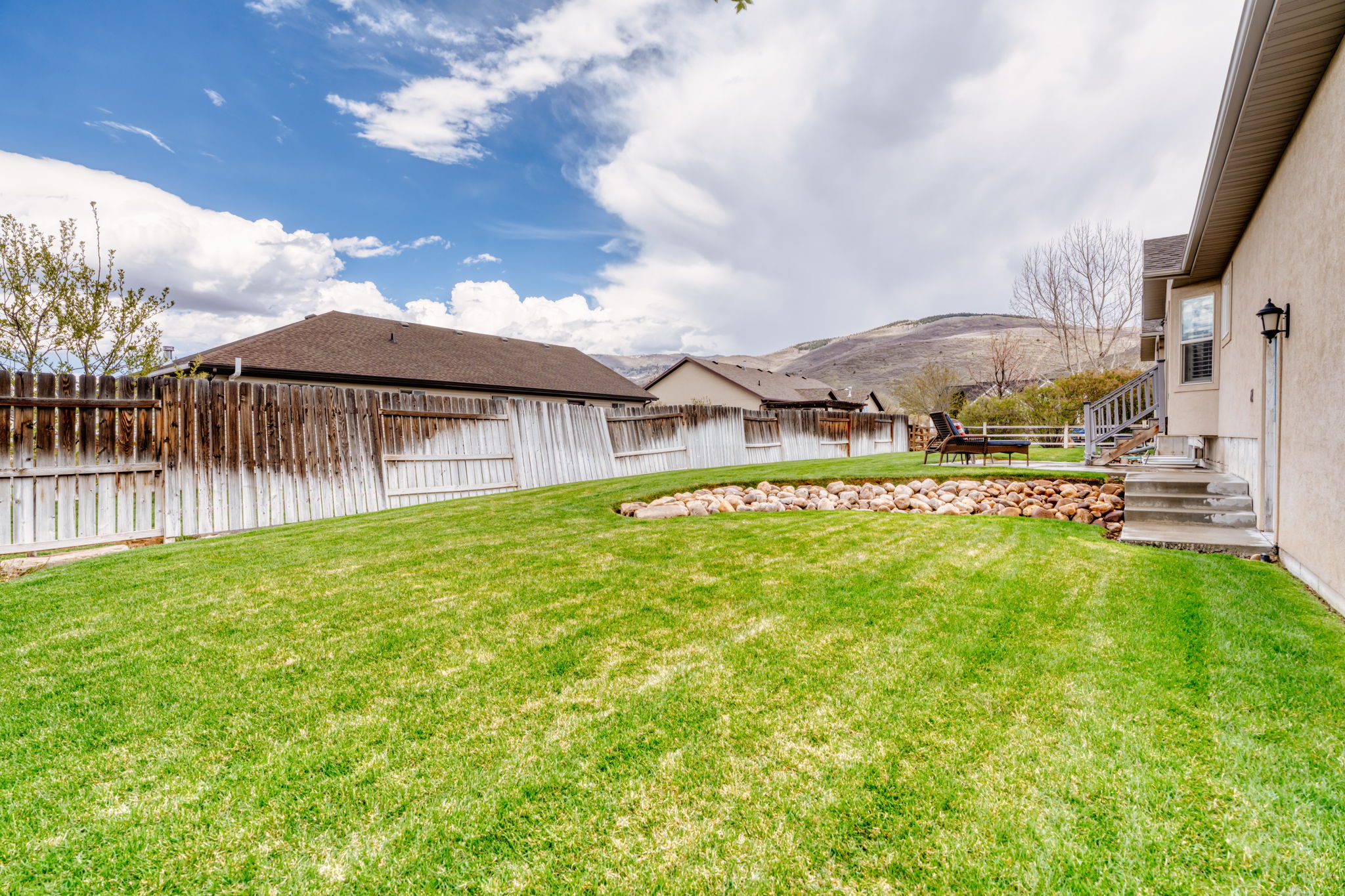 Fenced backyard with a mountain view and a patio