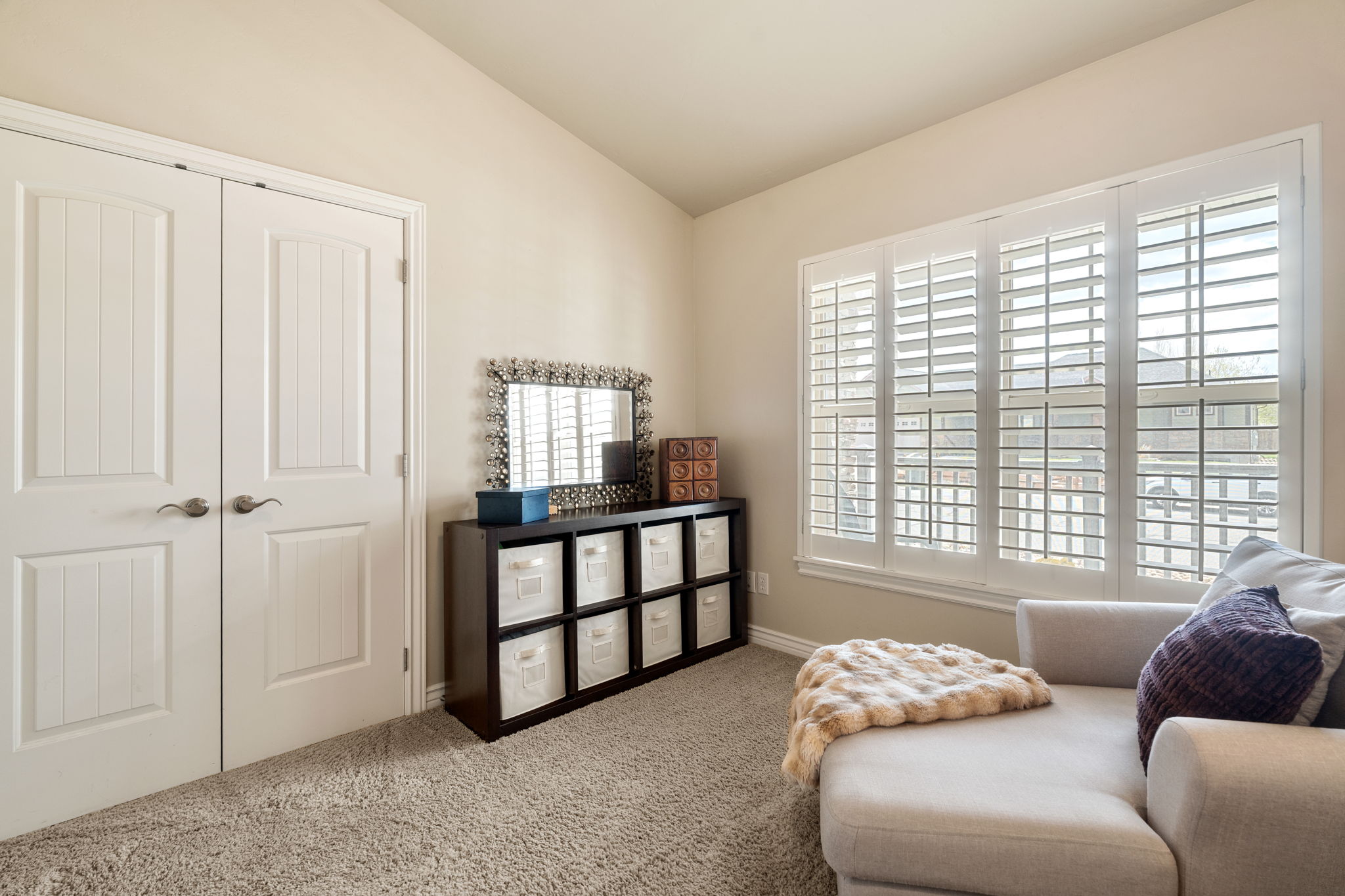 Sitting room featuring vaulted ceiling and light carpet