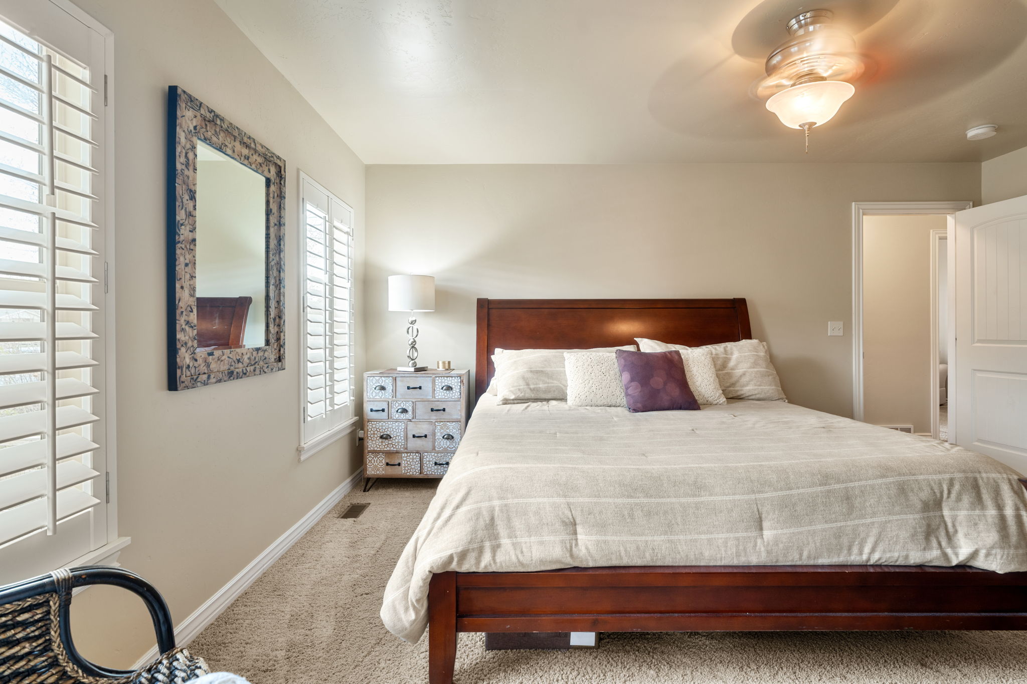 Carpeted bedroom with baseboards and a ceiling fan