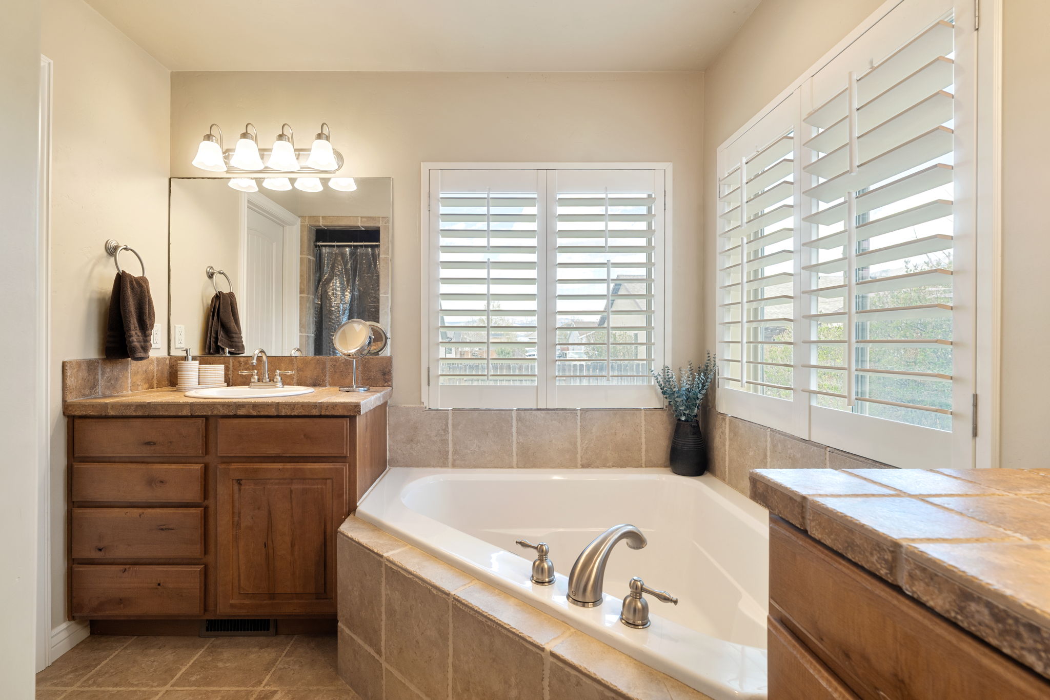 Full bathroom with vanity, a bath, a shower with curtain, and tile patterned floors