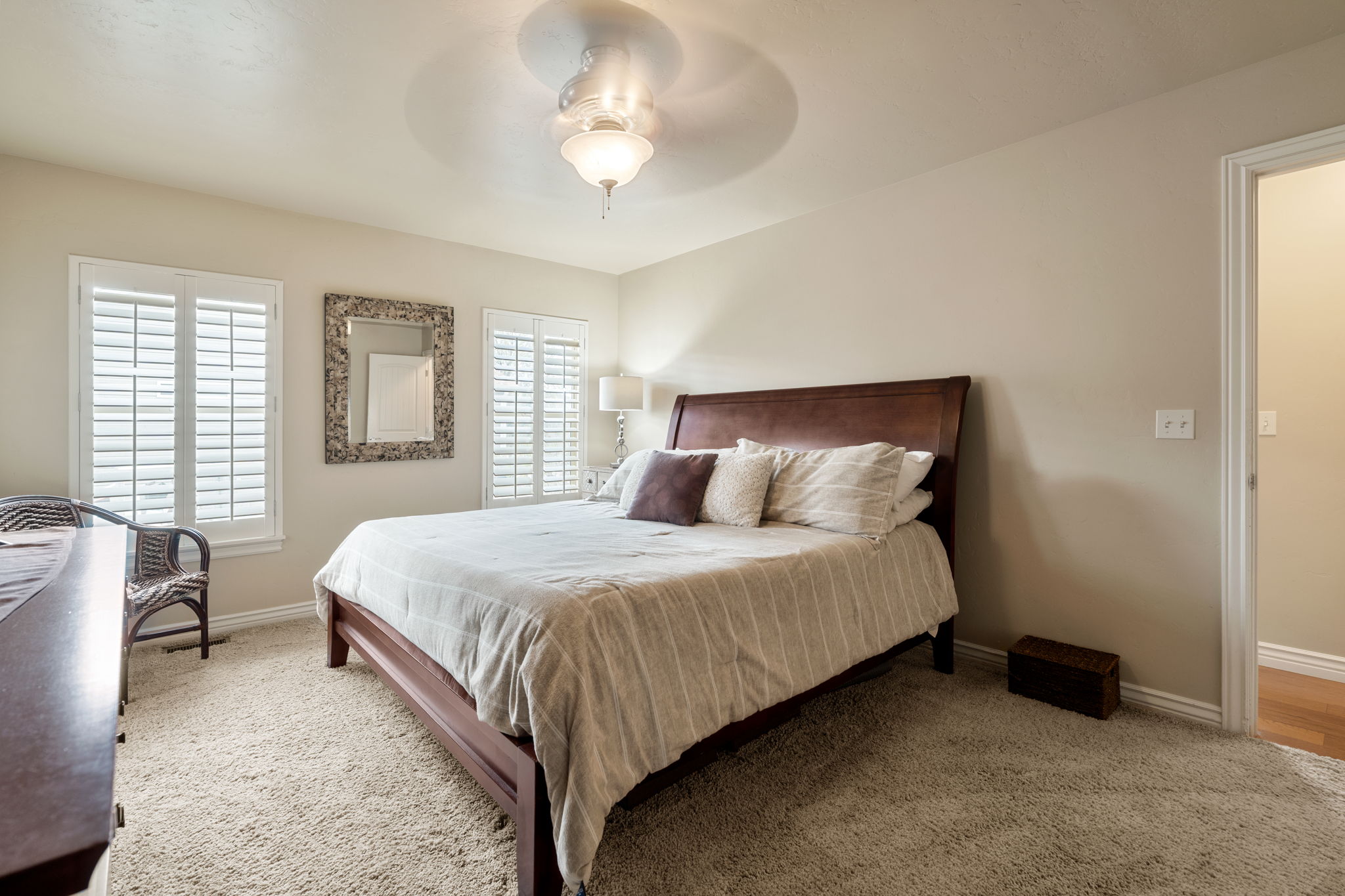 Bedroom featuring light colored carpet and a ceiling fan
