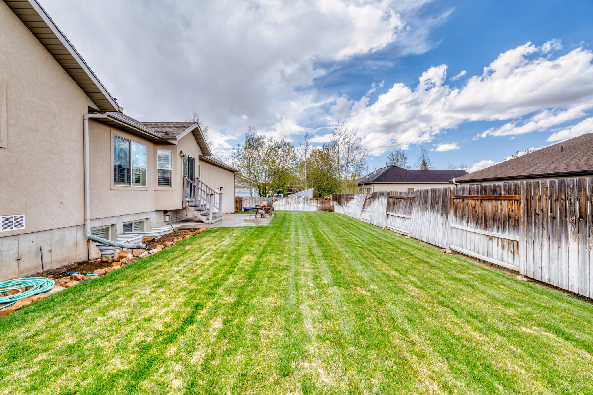 Fenced backyard with entry steps