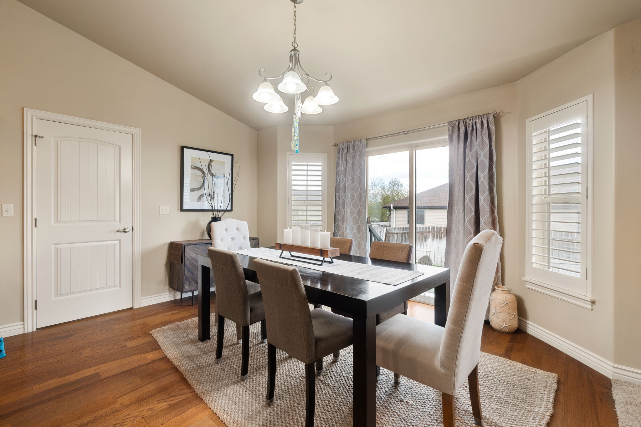 Dining space featuring a chandelier, dark wood-style flooring, and vaulted ceiling